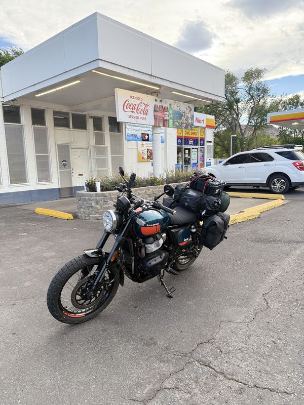 The Bear 650 parked in front of a Shell station with a vintage Coca-Cola sign