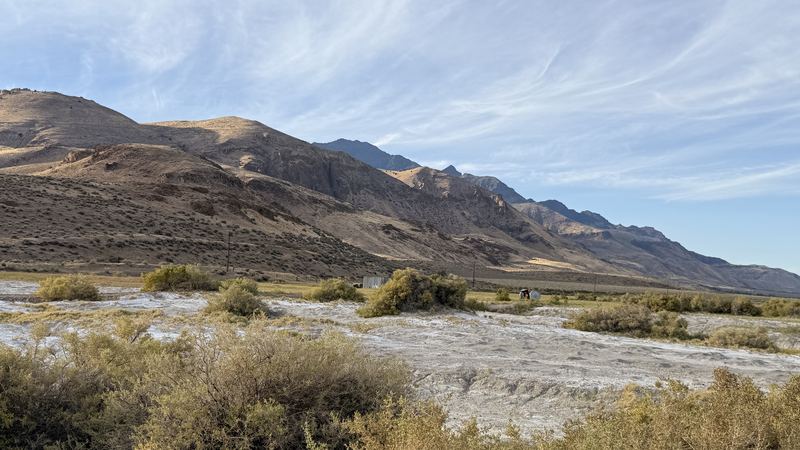 Brown mountains rising above a white salt flat