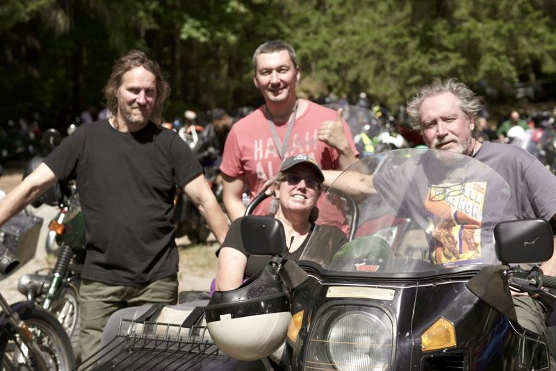 Riders posing together beside a sidecar motorcycle at the Vashon TT