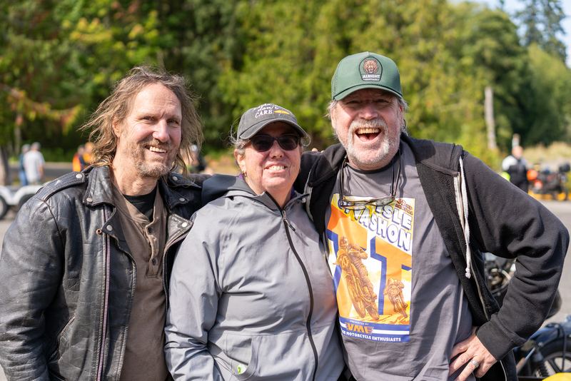 Three riders posing with their arms around each other at the Vashon TT