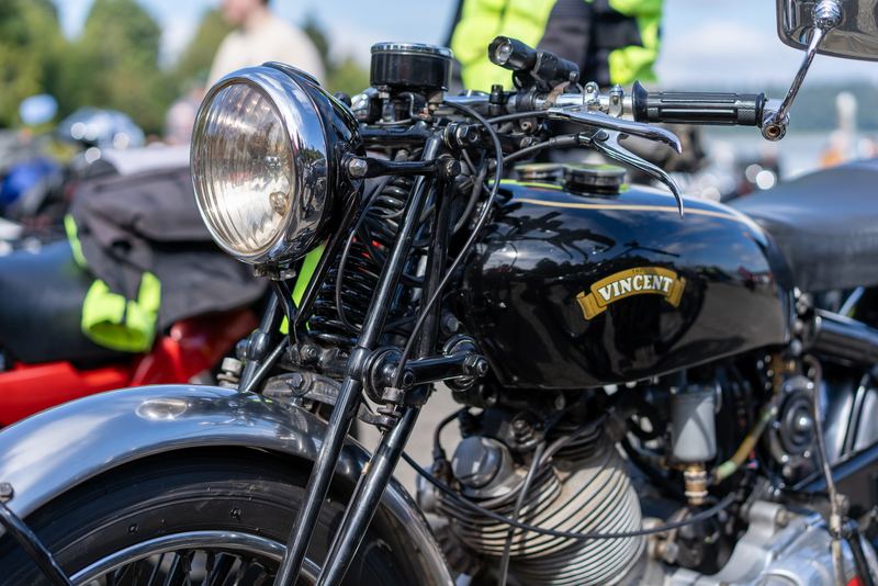Close-up of the headlight and tank of a black Vincent motorcycle