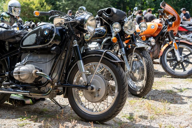A BMW boxer twin parked among other vintage bikes